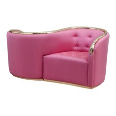 a pink couch with gold trimmings on the arm and back, sitting in front of a white background