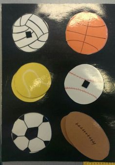 an assortment of different types of sports balls on a black board with a measuring tape