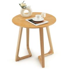 a wooden table with a magazine and coffee cup on it, against a white background