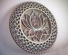 an intricately designed plate is displayed on the wall