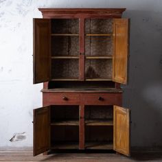 an old wooden cabinet with two doors open