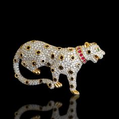 This brooch has me lost for words as it is immaculately done with beautiful details and a nice size enveloped in gold and rhodium plating.The Brooch has been casted in two parts with clear stones surrounding the entire body most likely Diamante (simulate clear diamonds) and black (simulate black diamonds) stones as the leopards spots, it also has a collar surrounded in red stone (simulate red rubies), and beautiful green eyes (simulate emeralds); enveloped in gold plating.This is a pre-owned ite Luxury Silver Rhinestone Brooches, Luxury Silver Brooches With Rhinestones, Luxury Rhinestone Brooch For Formal Occasions, Luxury Rhinestone Brooches For Formal Occasions, Lost For Words, Jaguar Leopard, Vintage Stemware, Beautiful Green Eyes, Black High Top Converse