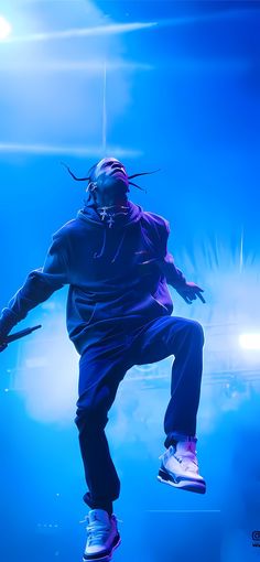 a man with dreadlocks jumping in the air