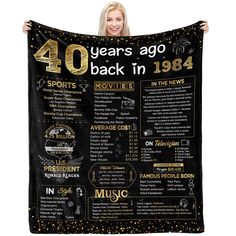 a woman holding up a black and gold poster with the words 40 years ago back in 1994