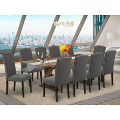 a dining room table surrounded by gray chairs and a large window overlooking the cityscape