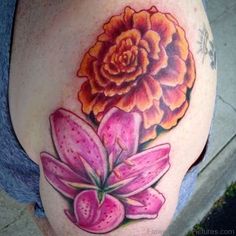 a woman's thigh with a flower tattoo on it