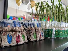 several bags and balloons are on the counter in front of some bamboo plant decorations,