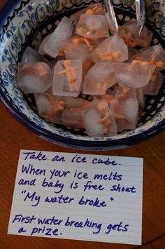 a bowl filled with ice cubes next to a sign that reads, ice baby