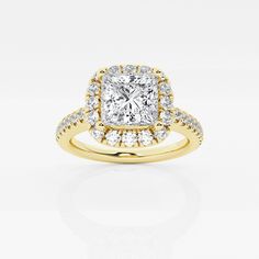 a yellow gold ring with a cushion cut diamond in the center