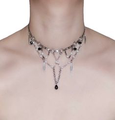 Grunge Goddess Choker  🖤 Unleash your edgy side with this statement choker, a fusion of rebellion and elegance. ⛓️ Layered and textured silver chain capturing the essence of the grunge aesthetic. White glass beads and black faceted glass beads create a striking interplay of light and dark. Faux pearls add a hint of unexpected femininity. Silver spikes add a touch of punk rock edge. The crowning touch a black teardrop bead, symbolizing a touch of mystery and individuality. 🖤 Only one available Layered Chokers, Aesthetic White, Statement Choker, Teardrop Beads, Faceted Glass, Chain Choker, Grunge Aesthetic, Black Glass, Punk Rock