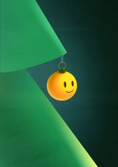 a smiley face ornament hanging from a green wall with a black background and white lines