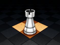 a metal chess piece sitting on top of a wooden board