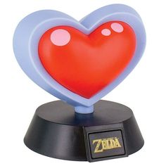 the legend of zelda heart lamp is on top of a black base with red and blue hearts