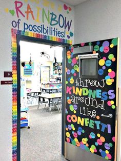 a classroom door decorated with rainbow colors and writing on the front, saying you're rainbow of possibilities