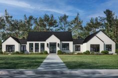 a white house with black shingles and trees in the background