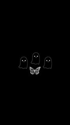 three black and white ghost faces in the dark with a butterfly sitting on top of them