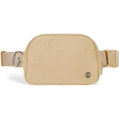 a tan leather belt bag with water drops on the front and side zippered closures