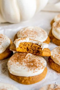 pumpkin cookies with cream cheese frosting on top