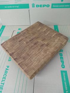 a wooden cutting board sitting on top of boxes