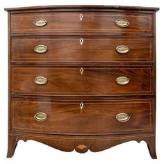 an antique chest of drawers with brass pulls and knobs on the top, against a white background