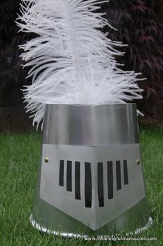 a metal bucket with white feathers in it