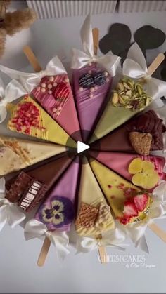 there are many different types of candies on the cake plate with toothpicks