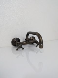 a faucet with two handles on a white counter