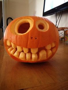 a pumpkin with teeth carved into it