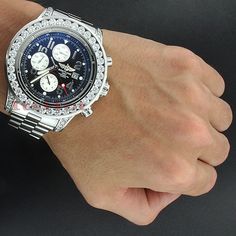 This Custom Men's Breitling Aeromarine Super Avenger Diamond Watch features 14.12 carats of genuine diamonds on the bezel and the lugs of the silver tone stainless steel case; and a silver tone stainless steel band. This Breitling men's diamond watch showcases a black dial with three chronograph subdials and a date display window at the 3 o'clock position. Luxury Watches With Cubic Zirconia Bling, Luxury Watches With Bling And Cubic Zirconia, Formal Diamond Watches With Bling, Luxury Diamond White Watch With Bling, Luxury Diamond Watch With Bling For Formal Events, White Gold Diamond Watch With Bling, Diamond Bling Watches For Anniversary, Silver Platinum Jewelry And Watches With Diamond Accents, Platinum Silver Jewelry And Watches With Diamond Accents