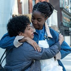 two women embracing each other on the street