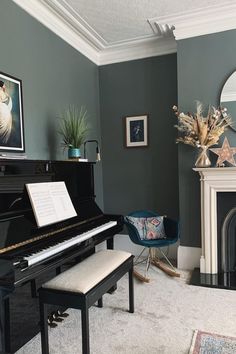 a living room filled with furniture and a piano in front of a fire place next to a fireplace