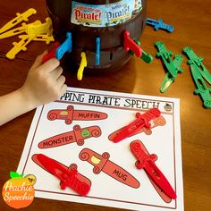 a child's hand is on top of a paper plate with magnets attached to it