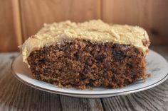 a close up of a slice of cake on a plate with frosting and crumbs