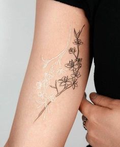 a woman with a flower tattoo on her arm