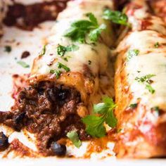 a close up of a plate of food with meat and cheese on it, including bread