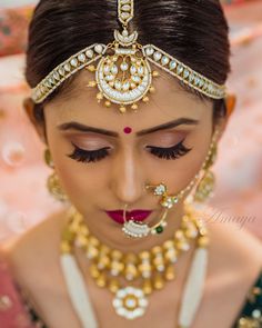 a woman with makeup and jewelry on her face