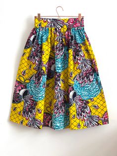 "Multicolour African high waist full gathered skirt. Perfect for casual outfits and special ocasions with pair of trainers or high heels. Skirt with elastic at the back of waist.  Two side pockets. Midi length skirt about 70 cm  + 5 cm waistband. Handmade in UK.  HOW TO CHOOSE A SIZE ?   Using a measuring tape, measure the smallest part of your waist.  SIZE CHART: (CM) XS - W: 66 CM S - W: 70 CM M - W: 74 CM  L - W: 78 CM  XL - W: 82 CM  CARE INSTRUCTIONS: Hand wash only, do not bleach, hang dry, do not tumble dry, press with a cool iron on the reverse side.  Please message me before purchasing so I can check availability. If you wish this skirt set in any other fabric, shorter or longer \"send message to seller\".  *Depends on computer/monitor settings colours might be different." Multicolor Pleated Skirt Dress For Spring, Spring Multicolor Pleated Skirt Dresses, Multicolor Spring Dress With Pleated Skirt, Multicolor Midi Skirt Dress For Summer, Spring Multicolor Pleated Dress, Casual Multicolor Pleated Dress, Yellow Flowy Dress With Lined Skirt, Multicolor Summer Dress With Pleated Skirt, Multicolor Pleated Summer Dress