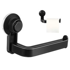 the toilet paper holder is black and has a roll of tissue on top of it