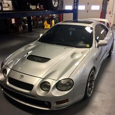 a silver sports car parked in a garage