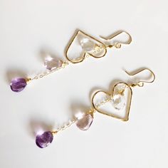 This earring is perfect to compliment any spring outfit with its purple ombré gemstone dangles and floating heart shape component. I used amethyst , pink amethyst and crystal quartz in this design. Hand shaped heart charm were slightly hammered for textures and shine, measured about 1.25 inches in size. Earring is about 3 inches long including ear wires. Handmade gold filled French ear wires. Purple Dangle Heart Earrings For Pierced Ears, Delicate Dangle Earrings For Valentine's Day, Elegant Heart Earrings With Dangling Charms As Gift, Dangle Heart Earrings For Wedding, Wedding Heart Beads Drop Earrings, Elegant Purple Heart Earrings As Gift, Handmade Purple Heart Dangle Earrings, Handmade Purple Dangle Heart Earrings, Heart Beads Drop Earrings For Wedding