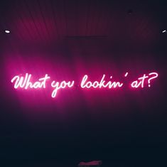 a neon sign that says what you lookin'at?