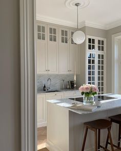 a kitchen with an island and two stools