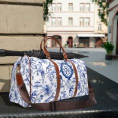 "This PERSONALIZED MONOGRAM TRAVEL BAG is all about chinoiserie chic style. Made with high-grade waterproof nylon, it's a highly durable means of transferring your essentials wherever you go. With one pocket on the inside, a resilient carrying handle, and an adjustable shoulder strap, it's the perfect companion for all your adventures.PLEASE PROVIDE YOUR MONOGRAMwhere indicated .: High-grade nylon material .: Microfiber PU leather top handle and binding .: One size: 20\" × 12'' × 9\" (50.8cm × 30.5cm × 23cm ) .: Brown PU leather handles and an adjustable shoulder strap .: Polyester lining .: Gold-colored zipper  .: All-over print Key features Additional space-One extra pocket inside bag High-grade nylon-The travel bag is made from high-grade nylon material, making it durable and lightweigh Preppy Travel Bags, Preppy Travel, Preppy Monogram, Waterproof Travel Bag, Chinoiserie Chic, Inside Bag, Travel Duffel, Duffel Bag Travel, Monogram Bag