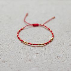 Our Fortune-bracelet is crafted with a red string and an array of gold beads for a radiant look. Each piece is handmade with love by female artisans. It’s said this magnificent bracelet brings luck, fortune, and protection to the wearer. Elegant Red Bracelets For Good Luck, Gold Hand-strung Braided Bracelets, Gold Jewelry For Friendship Festivals, Adjustable Gold Bracelet With Tiny Beads, Red Spiritual Bracelets For Festivals, Gold Spiritual Braided Bracelet For Good Luck, Gold Hand-strung Braided Bracelet For Festivals, Gold Braided Bracelet For Good Luck, Gold Braided Bracelets With Tiny Beads