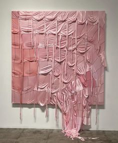 a large pink piece of art hanging on the wall