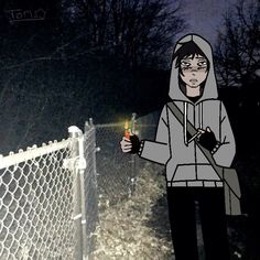 a person standing in front of a chain link fence holding a lit up bottle and wearing a hoodie