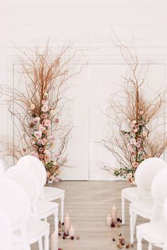 the ceremony room is decorated with white chairs and floral arrangements