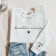 a white shirt with the words'daddy mama'written on it next to jeans and a disco ball