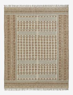 a beige and brown rug with fringes on the bottom, in an ornate pattern