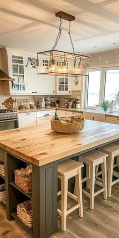 a large kitchen island with stools in front of it and baskets on the counter